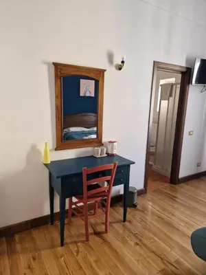 a blue desk with a chair and a mirror at Pepe's Place - Carlo Alberto in Rome