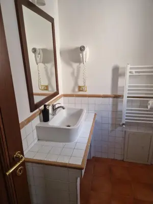 a bathroom with a sink and a mirror at Pepe's Place - Carlo Alberto in Rome