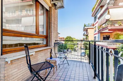 a balcony with two chairs and a window at Luxury Giorgi Home in Rome