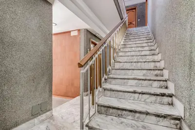 a staircase in a house with concrete walls at Luxury Giorgi Home in Rome