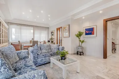 a living room with blue couches and a table at Luxury Giorgi Home in Rome