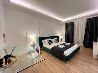 a bedroom with a bed and a glass table at Luxury Suite Rialto in Rome