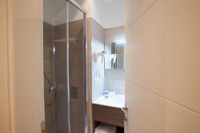 a bathroom with a shower and a sink at Melody Suite Rome in Rome