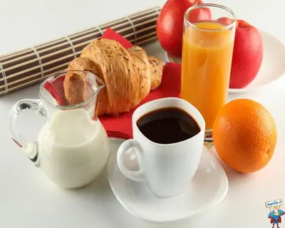 a table with a cup of coffee and a plate of food at Melody Suite Rome in Rome