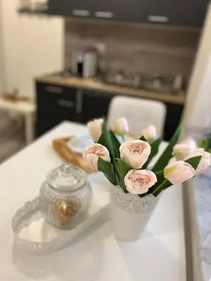 a vase filled with pink flowers on a table at MARAND HOUSE ROME in Rome