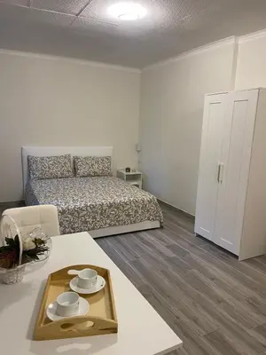 a bedroom with a bed and a table with a tray at MARAND HOUSE ROME in Rome