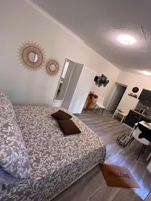 a bedroom with a bed and a mirror on the wall at MARAND HOUSE ROME in Rome