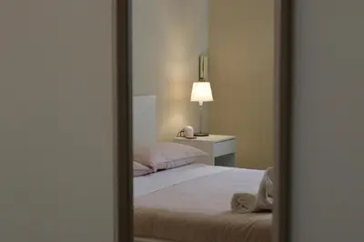 a mirror reflection of a bed in a bedroom at Policlinico Apartment in Rome