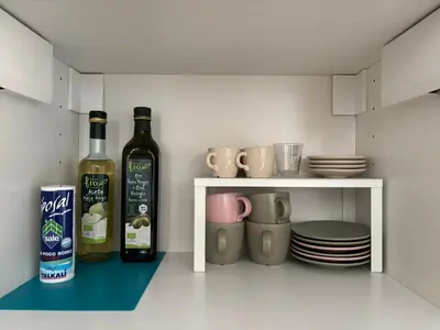 two bottles of wine sitting on a shelf in a kitchen at Policlinico Apartment in Rome