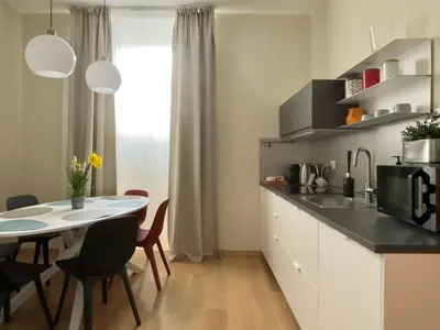 a kitchen and dining room with a table and chairs at Policlinico Apartment in Rome