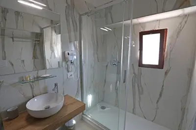 a bathroom with a sink and a shower and a toilet at Romerooms Condotti in Rome
