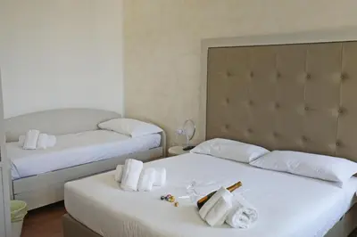 two beds in a hotel room with towels on them at Romerooms Condotti in Rome