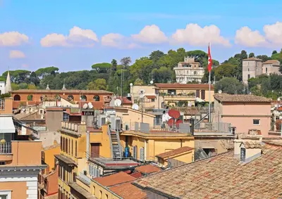 a view of a city with roofs and buildings at Romerooms Condotti in Rome