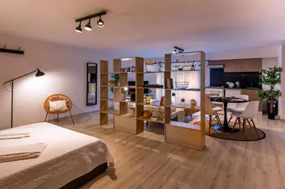 a bedroom with a room with a bed and a table at Suite a pochi passi da S. Pietro in Rome