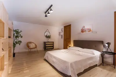 a bedroom with a bed and a table and a chair at Suite a pochi passi da S. Pietro in Rome