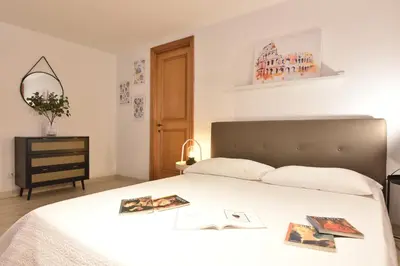 a bedroom with a bed with two pictures on it at Suite a pochi passi da S. Pietro in Rome