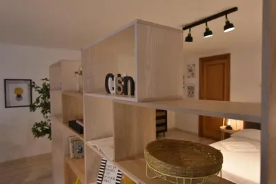 a room with a bed and a shelf with a chair at Suite a pochi passi da S. Pietro in Rome