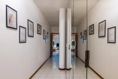 a hallway with framed pictures on the walls at Suite a pochi passi da S. Pietro in Rome