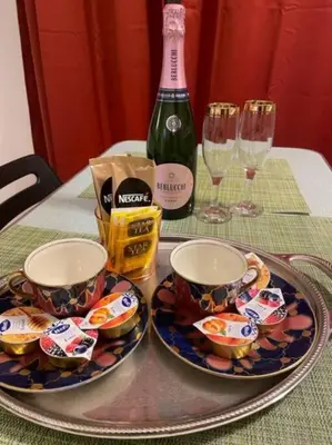 a table with two cups and a bottle of wine at House of Cardinals in Rome