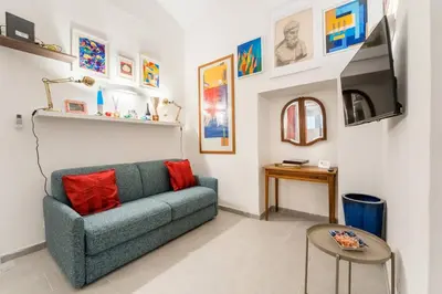 a living room with a couch and a tv at House of Cardinals in Rome
