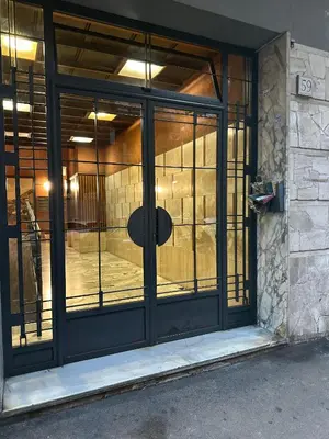 an entrance to a building with glass doors at Le Quattro Lune, Roma Centro in Rome