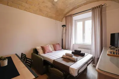 a small bedroom with a bed and a window at [Termini Treasure] - Elegant retreat in Rome
