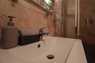 a bathroom sink with a soap dispenser on top of it at [Termini Treasure] - Elegant retreat in Rome