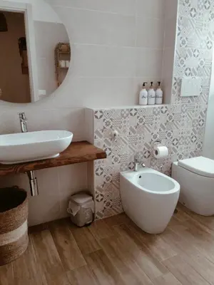 a bathroom with a sink and a toilet and a mirror at The green place alloggio turistico in Rome