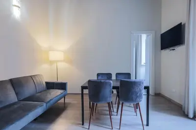 a living room with a couch and a table and chairs at Prefetti 46 in Rome