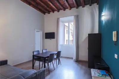 a living room with a table and chairs and a couch at Prefetti 46 in Rome