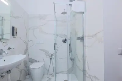 a bathroom with a shower and a toilet and a sink at Prefetti 46 in Rome