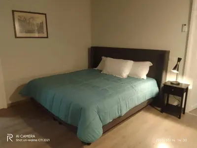 a bedroom with a bed with a green comforter and a lamp at Prefetti 46 in Rome