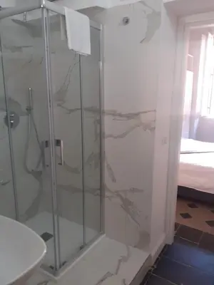 a shower with a glass door in a bathroom at Prefetti 46 in Rome