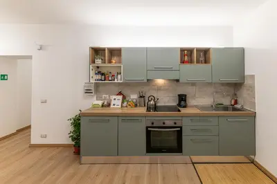 a kitchen with gray cabinets and a sink at Domus Dino in Rome