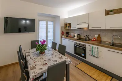 a kitchen and dining room with a table and chairs at Domus Dino in Rome