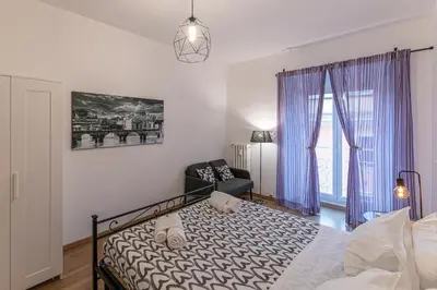 a bedroom with a bed and a chair at Domus Dino in Rome