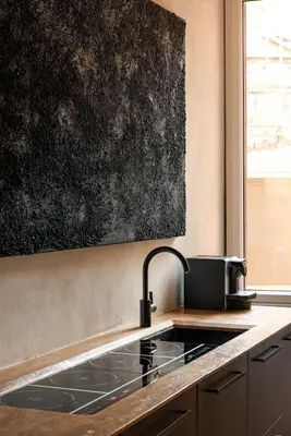 a kitchen with a sink and a black wall at Casa Monti Club in Rome