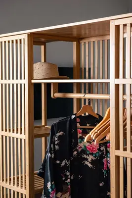 a wooden shelf with clothes and a hat on it at Casa Monti Club in Rome