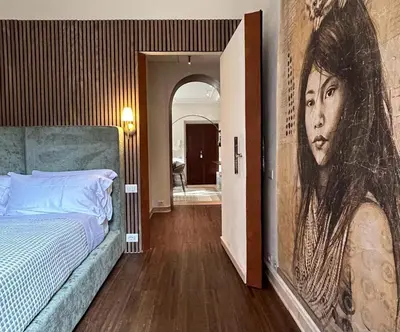 a bedroom with a large painting of a woman at Casa Monti Club in Rome