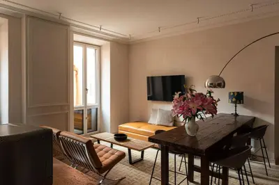 a living room with a table and a couch at Casa Monti Club in Rome