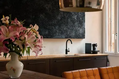 a kitchen with a sink and a vase of flowers on a table at Casa Monti Club in Rome