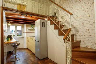 a kitchen with a refrigerator and a staircase at B5 Apartment Vatican in Rome
