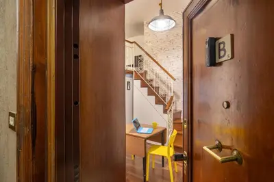 a hallway with a table and a desk with a laptop at B5 Apartment Vatican in Rome