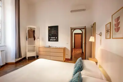 a living room with a bed and a dresser in it at B5 Apartment Vatican in Rome
