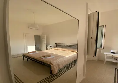 a bedroom with a bed and a large mirror at Dew Vatican Apartment in Rome