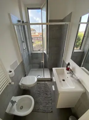 a bathroom with a toilet and a sink and a shower at Dew Vatican Apartment in Rome