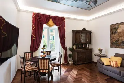 a living room with a table and a couch at Idyllia - Classy apartment in Vatican area in Rome
