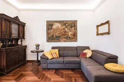 a living room with a couch and a painting on the wall at Idyllia - Classy apartment in Vatican area in Rome