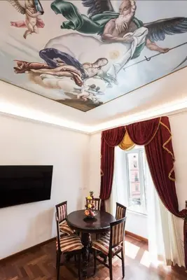 a dining room with a table and a painting on the ceiling at Idyllia - Classy apartment in Vatican area in Rome