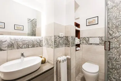 a bathroom with a sink and a toilet at Idyllia - Classy apartment in Vatican area in Rome